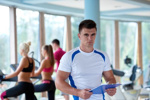 group portrait of healthy and fit young people in fitness gym