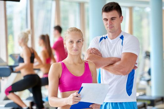 group portrait of healthy and fit young people in fitness gym