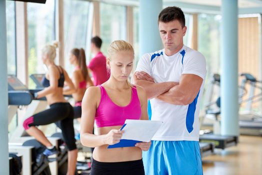 group portrait of healthy and fit young people in fitness gym