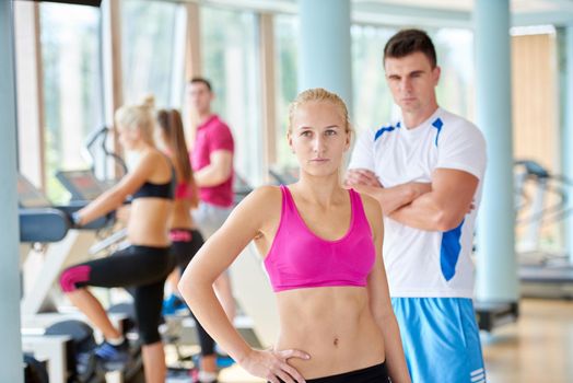 group portrait of healthy and fit young people in fitness gym