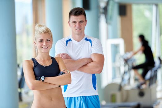 group portrait of healthy and fit young people in fitness gym