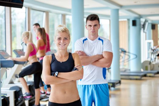 group portrait of healthy and fit young people in fitness gym