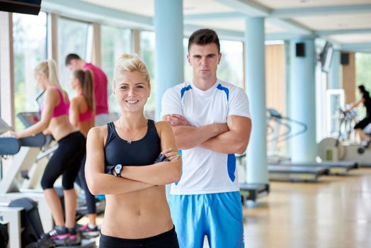 group portrait of healthy and fit young people in fitness gym