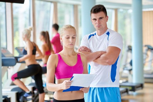 group portrait of healthy and fit young people in fitness gym