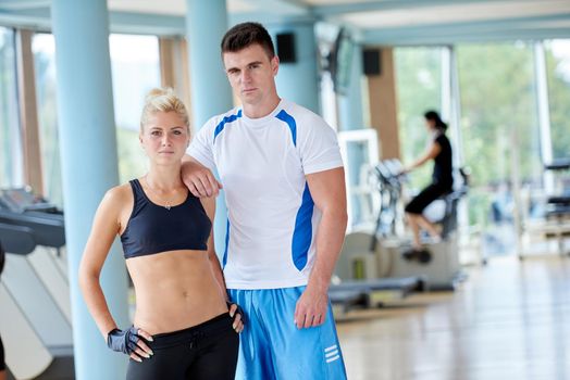 group portrait of healthy and fit young people in fitness gym