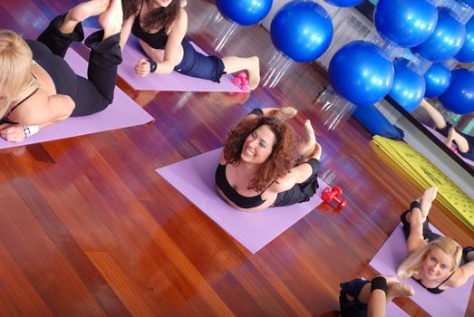 health club: women doing stretching, fitness, aerobics and yoga exercise