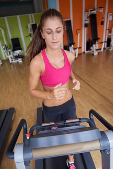 sport, fitness, lifestyle, technology and people concept - smiling woman exercising on treadmill in gym