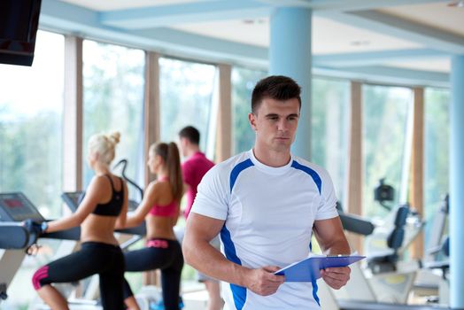 group portrait of healthy and fit young people in fitness gym