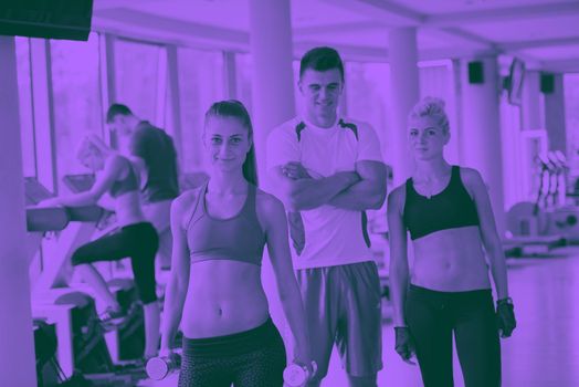 group portrait of healthy and fit young people in fitness gym duo tone