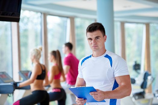 group portrait of healthy and fit young people in fitness gym