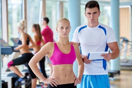 group portrait of healthy and fit young people in fitness gym