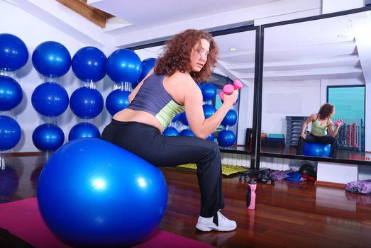 young pretty woman exercising in a fitness center