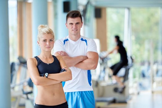 group portrait of healthy and fit young people in fitness gym