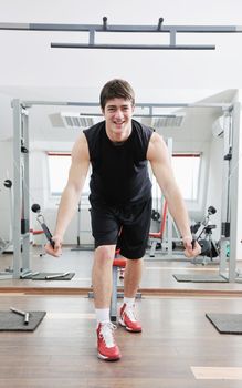 young man in fintess sport club exercise withweights and relaxing