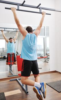 young man in fintess sport club exercise withweights and relaxing