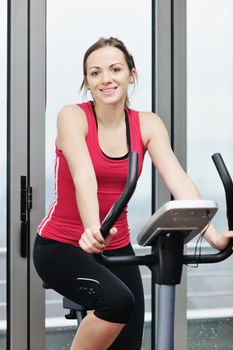 young woman exercise fitness and workout while run on track in sport club