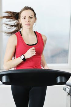 young woman exercise fitness and workout while run on track in sport club