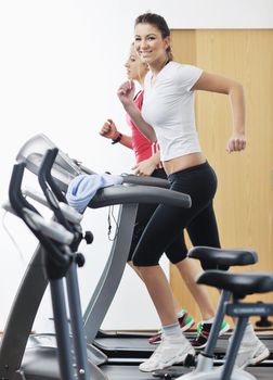 young woman exercise fitness and workout while run on track in sport club