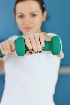 beaudiful young woman fitness workout with weights at sport club