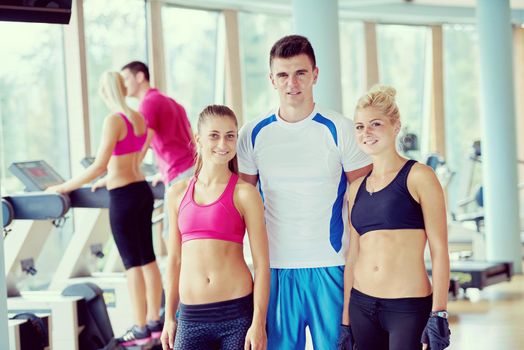 group portrait of healthy and fit young people in fitness gym