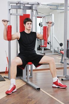 young man in fintess sport club exercise withweights and relaxing