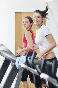 young woman exercise fitness and workout while run on track in sport club