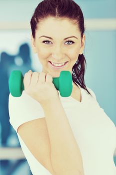 beaudiful young woman fitness workout with weights at sport club