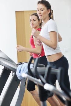 young woman exercise fitness and workout while run on track in sport club