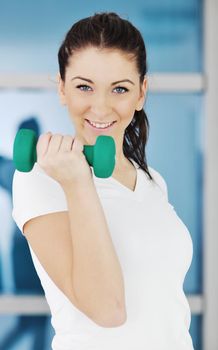 beaudiful young woman fitness workout with weights at sport club