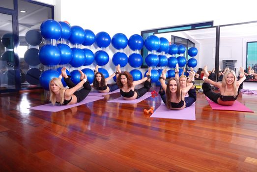 health club: women doing stretching, fitness, aerobics and yoga exercise