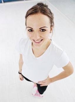 happy diet concept with young woman on pink scale at sport fitnes gym club