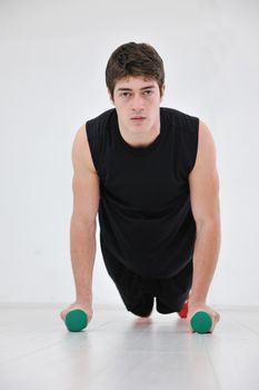 young man in fintess sport club exercise withweights and relaxing