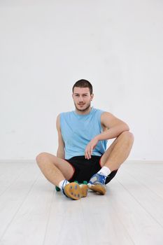 young man in fintess sport club exercise withweights and relaxing