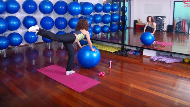 young pretty woman exercising in a fitness center