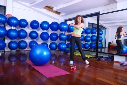 young pretty woman exercising in a fitness center