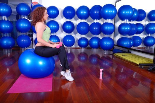 young pretty woman exercising in a fitness center