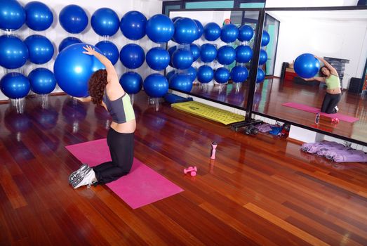 young pretty woman exercising in a fitness center