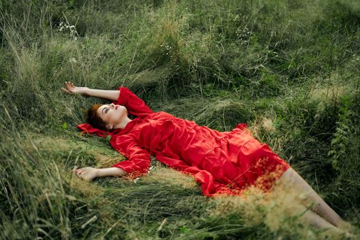 woman in a black dress lies in a field nature fashion summer. High quality photo