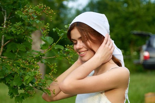 cheerful woman outdoors in the garden countryside ecology nature. High quality photo