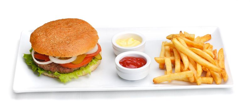 still life with fast food hamburger menu, french fries, soft drink and ketchup