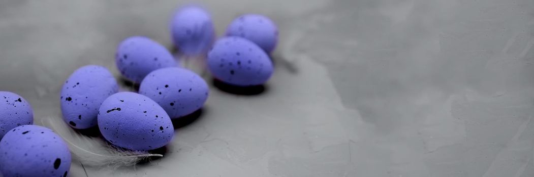 Quail eggs painted in the trending color of 2022 are Very Peri. Easter 2022. Demonstrating the colors of 2022 - Very Peri. The concept of changing the colors of the year. Extremely Gray and Very Peri.