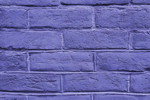 Cracked and textured purple wall, brick wall background. The color of the 2022 concept. Close up. Fashionable very peri color of the season.