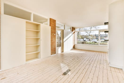 Large cozy empty room with window and wooden floor