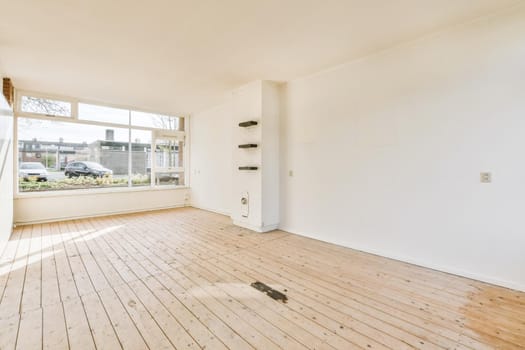 Large cozy empty room with window and wooden floor