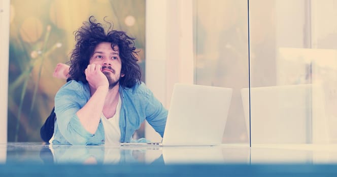 Real man Using laptop on the floor At Home  Enjoying Relaxing