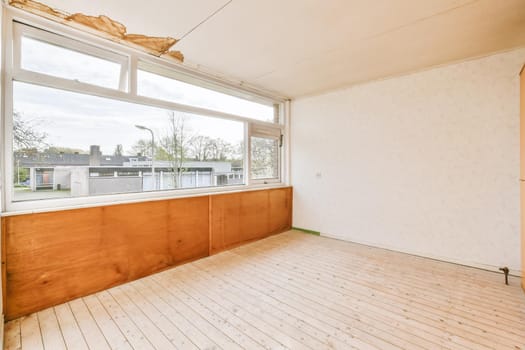 Large cozy empty room with window and wooden floor