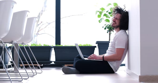 Real man Using laptop on the floor At Home  Enjoying Relaxing