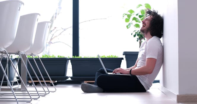 Real man Using laptop on the floor At Home  Enjoying Relaxing