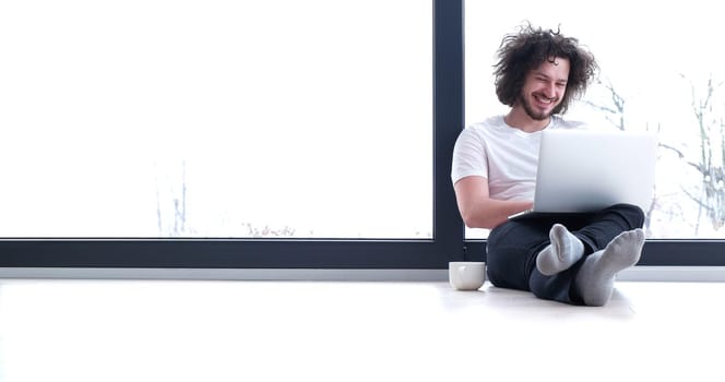 Real man Using laptop on the floor At Home  Enjoying Relaxing