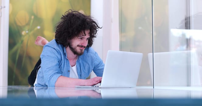 Real man Using laptop on the floor At Home  Enjoying Relaxing